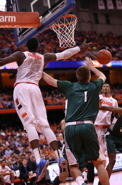 Christmas stretches his arm out in an attempt for a ball.