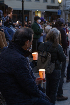 A man holds his candle during a moment of silence.