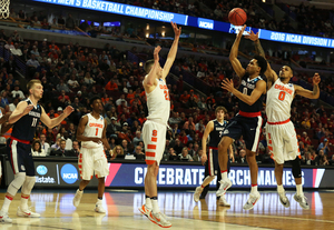 Michael Gbinije extends his right arm just as Silas Melson lofts a floater toward the basket in Syracuse and Gonzaga's Sweet 16 matchup.