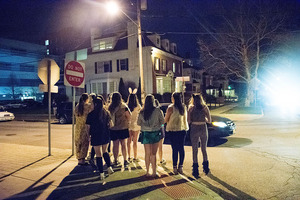 Girls dressed up as Alice In Wonderland themed outfits wait to cross the street at SU on a night out.