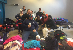 Eric Devendorf (back left) at a coat drive at the Museum of Science and Technology in Syracuse held in December.