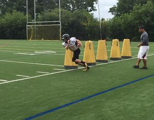 Starting quarterback Alex Doughty goes through drills at Henninger practice.