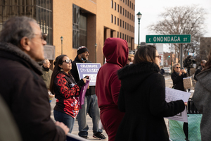 Danielle Smith, a member of the Onondaga Nation, stands alongside other Syracuse community members to protest the Columbus statue's place in the city's center.