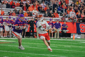 Cole Kirst (right) played a big role in his graduate season with Syracuse, tallying 37 points and earning All-ACC Team honors.