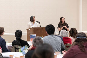 Vice President for Diversity and Inclusion Mary Grace A. Almandrez speaks in front of an audience of SU community attendees. Throughout the forum, she updated the public on the university's ongoing DEIA goals.