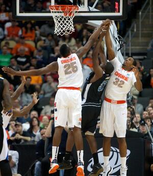 Syracuse forwards Rakeem Christmas (25) and Kris Joseph (32) will face a tough task on Saturday trying to defend 6-foot-11 Kansas State forward Jordan Henriquez.