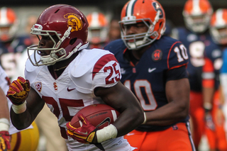 USC Trojans running back Silas Redd #25 is chased by Syracuse Orange defensive end Markus Pierce-Brewster. 