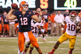 Syracuse Orange quarterback Ryan Nassib #12 is rushed to throw.