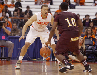 Syracuse guard Brandon Triche defends Bloomsburg guard Lorenzo Christmas.