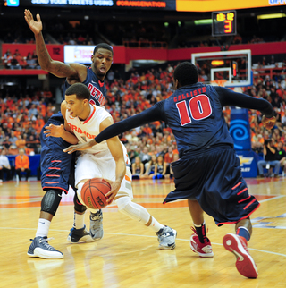 Michael Carter-Williams splits a couple of Detroit defenders as he drives to the basket in Syracuse's win over the Titans.