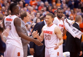 Brandon Triche high-fives teammates after exiting his Senior Night game with 15 points, five rebounds, four assists, three turnovers and a block in 35 minutes of play.