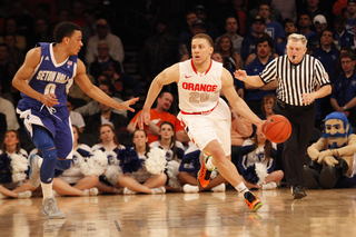 Brandon Triche drives the ball down the court past Sterling Gibbs.