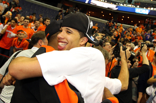 Michael Carter-Williams #1 of the Syracuse Orange celebrates with fans after their win over the Marquette Golden Eagles.