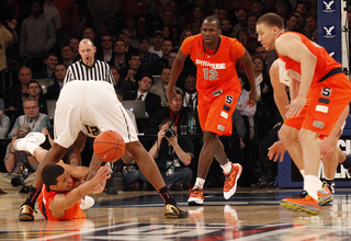 Michael Carter-Williams Passes the ball through the legs of Pittsburgh's Lamar Patterson (#21) to Brandon Triche.