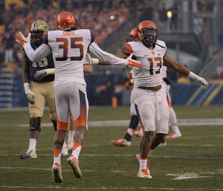 Davis and defensive end Ron Thompson high-five during the second half.