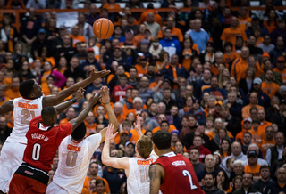 Roberson, Gbinije and Cooney fight for a loose ball with Rozier in the second half.