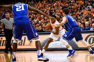 SU guard Ron Patterson looks to make a move against Duke guard Grayson Allen with Blue Devils forward Amile Jefferson looking on.