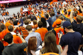 Students sing the alma mater after having rushed on the field. The Orange extended its record to 3-4 after the win.  