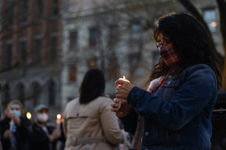 Fanny Patricia Villarreal holds onto her candle as everyone lights their candles during the moment of silence.