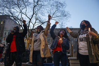 From left to right, Hasahn Bloodworth, Nodesia Hernandez, Fanny Patricia Villarreal and Nada Odeh raise their fists in the air as Bloodworth leads them through another round of chants to close out the vigil.
